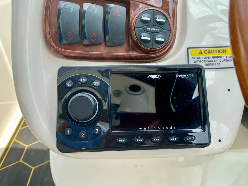 Slide: The Image of Control panel of a 2004 Sea Ray 290 SLX boat with audio system and caution label. - 15