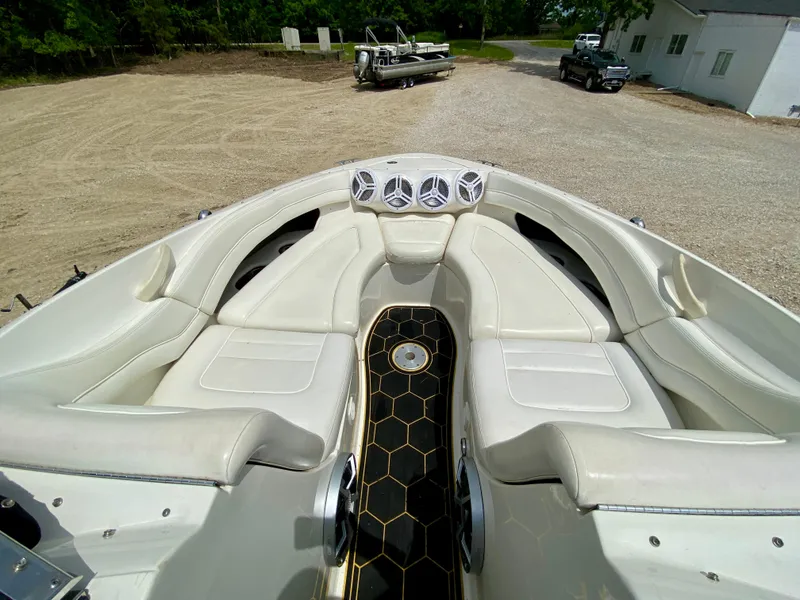 Slide: The Image of 2004 Sea Ray 290 SLX boat interior with white seating and hexagonal floor design. - 16