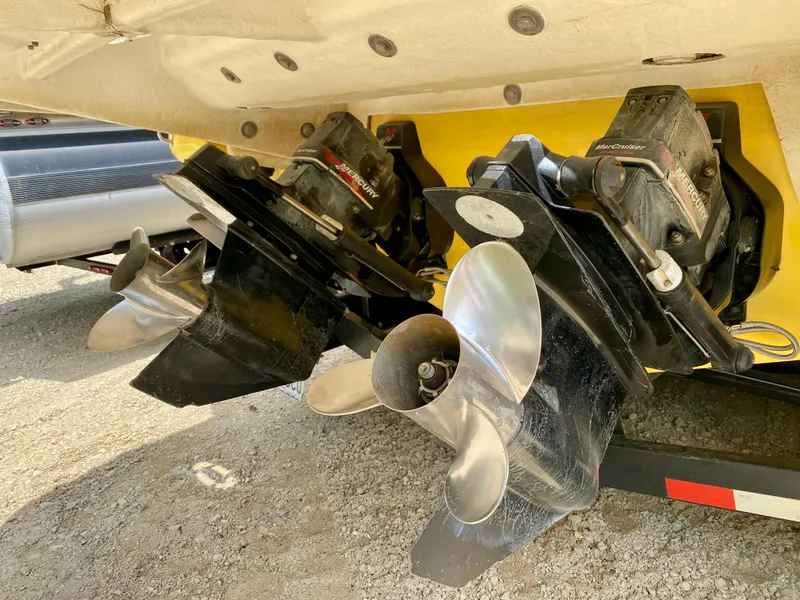 Slide: The Image of 2004 Sea Ray 290 SLX boat propellers and outdrives on a trailer. - 22