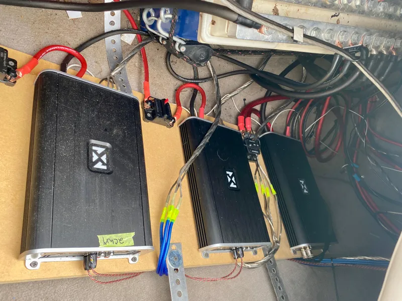 Slide: The Image of Audio amplifiers installed in a 2004 Sea Ray 290 SLX boat, showcasing wiring and connections. - 27