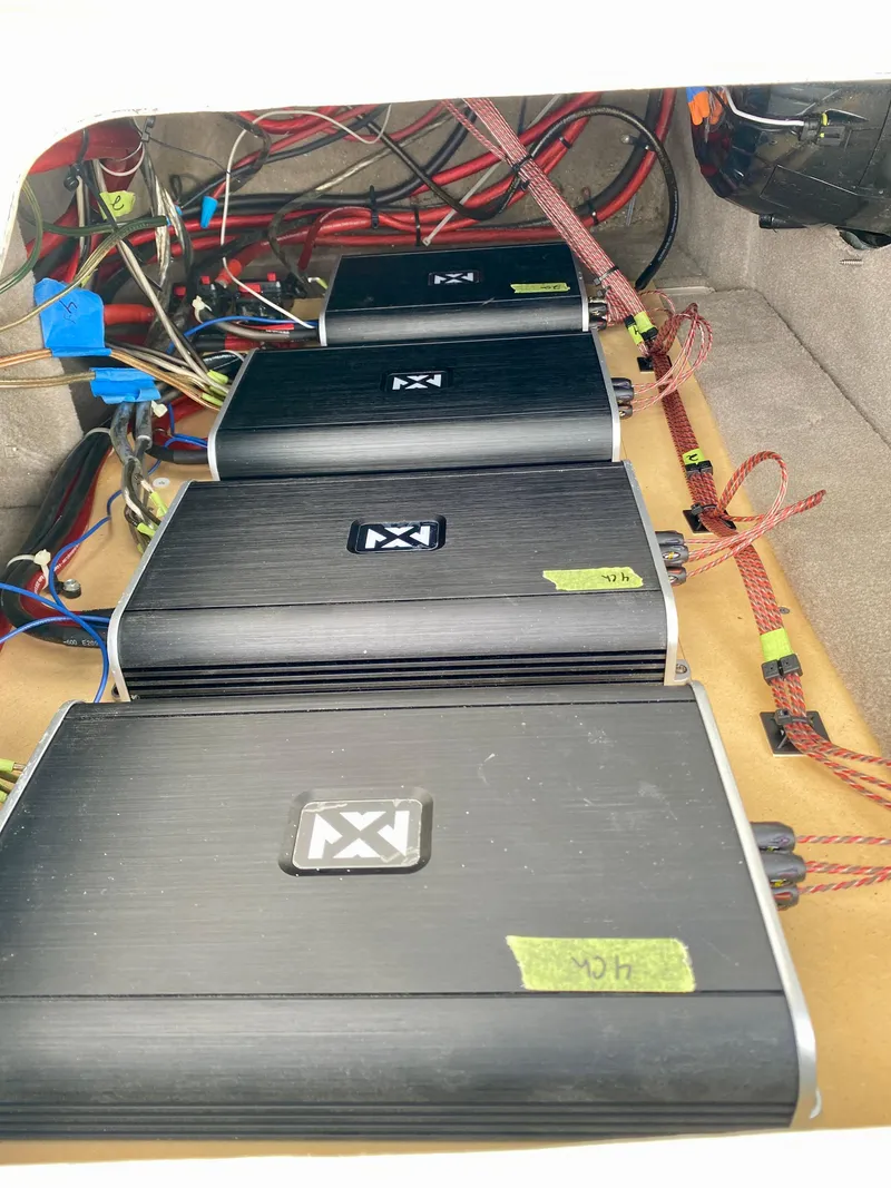 Slide: The Image of Audio amplifiers installed in a 2004 Sea Ray 290 SLX boat, showcasing wiring and setup. - 29