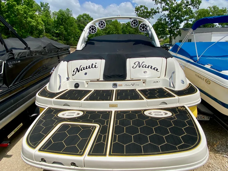 Slide: The Image of 2004 Sea Ray 290 SLX boat with custom deck design, docked outdoors. - 3