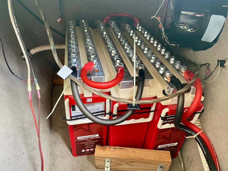 Slide: The Image of Battery compartment of a 2004 Sea Ray 290 SLX boat with wiring and connections. - 30