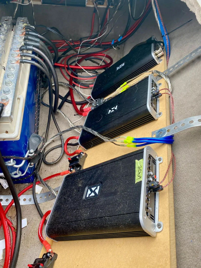 Slide: The Image of Audio amplifiers and wiring setup in a 2004 Sea Ray 290 SLX boat. - 31
