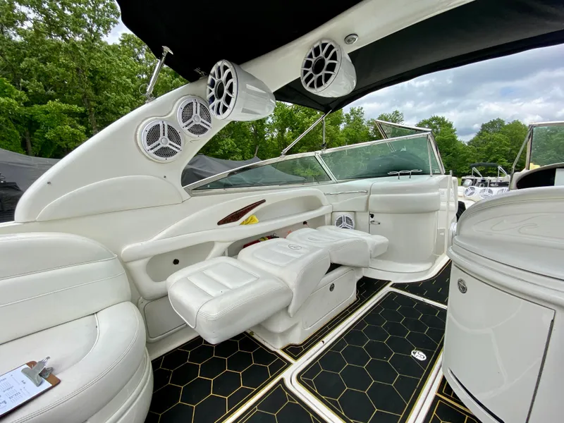 Slide: The Image of 2004 Sea Ray 290 SLX boat interior with white seating and black flooring. - 8