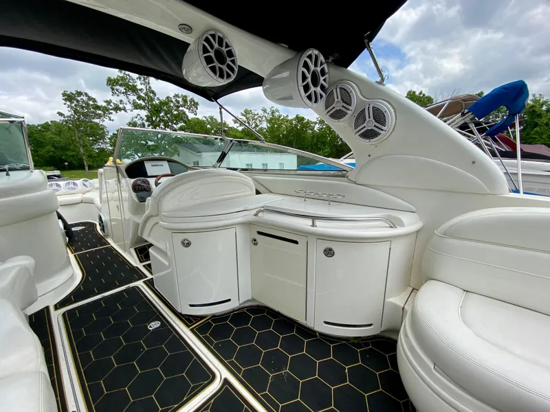 Slide: The Image of 2004 Sea Ray 290 SLX boat interior with sleek white seating and modern audio system. - 9