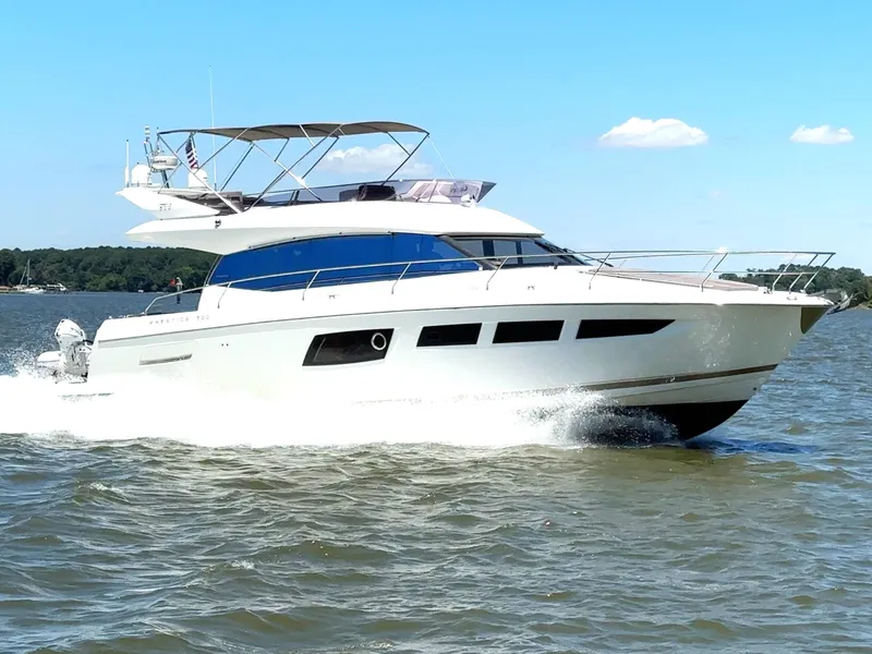 Slide: The Image of 2017 Prestige 500 yacht cruising on a sunny day with clear blue skies. - 0