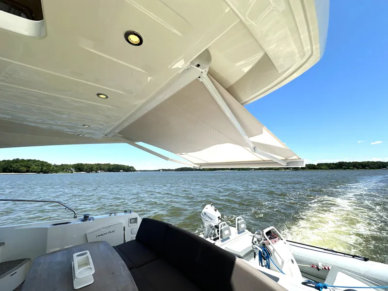 Slide: The Image of Prestige 500 yacht, 2017 model, cruising on a sunny lake with retractable awning. - 10