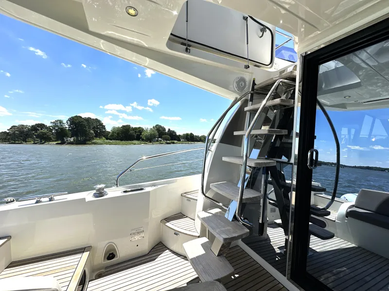 Slide: The Image of Luxurious 2017 Prestige 500 yacht deck with spiral staircase and scenic water view. - 11