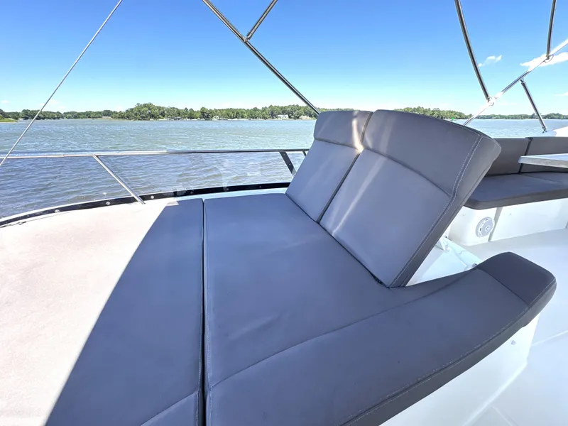 Slide: The Image of Luxurious seating on 2017 Prestige 500 yacht, overlooking serene waters. - 22