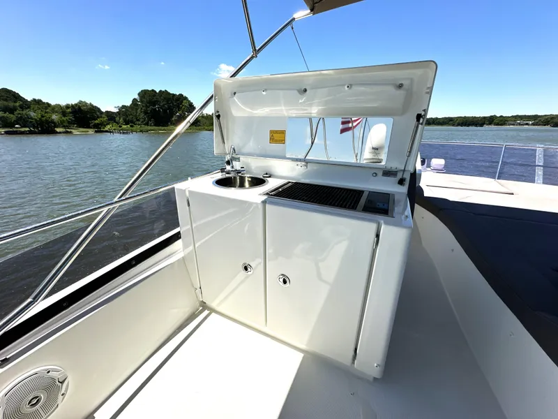 Slide: The Image of 2017 Prestige 500 yacht with outdoor kitchenette on deck, featuring sink and grill. - 27