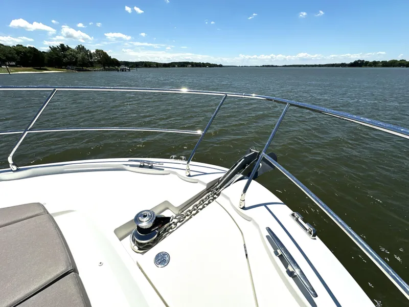 Slide: The Image of 2017 Prestige 500 yacht bow view on a sunny day, overlooking calm waters. - 32