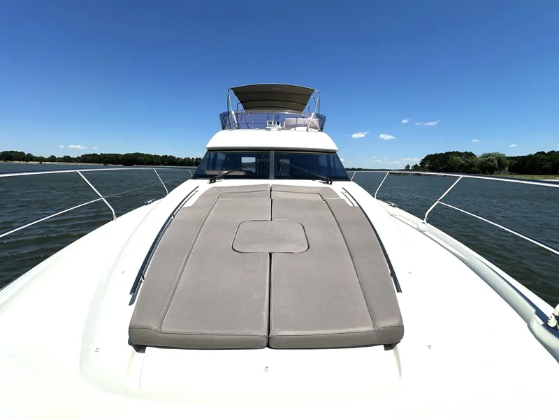 Slide: The Image of 2017 Prestige 500 yacht on open water under clear blue sky. - 33