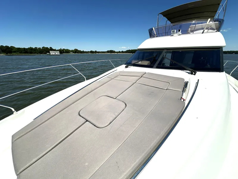 Slide: The Image of 2017 Prestige 500 yacht on water, featuring spacious sun deck and sleek design. - 34