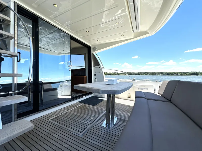 Slide: The Image of Luxurious 2017 Prestige 500 yacht deck with seating, table, and ocean view. - 38