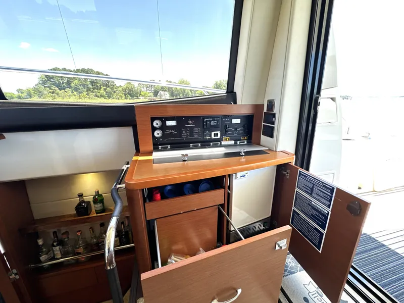 Slide: The Image of Control panel and bar area inside a 2017 Prestige 500 yacht. - 43