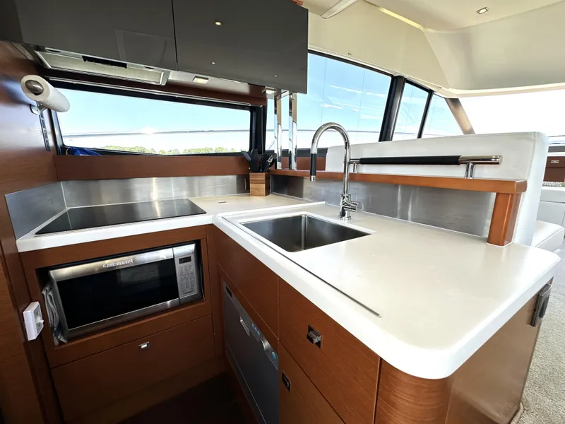 Slide: The Image of Modern kitchen interior on a 2017 Prestige 500 yacht, featuring sleek countertops and appliances. - 45