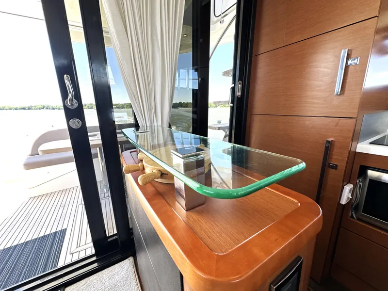 Slide: The Image of Luxurious interior of 2017 Prestige 500 yacht with glass table and wooden accents. - 47