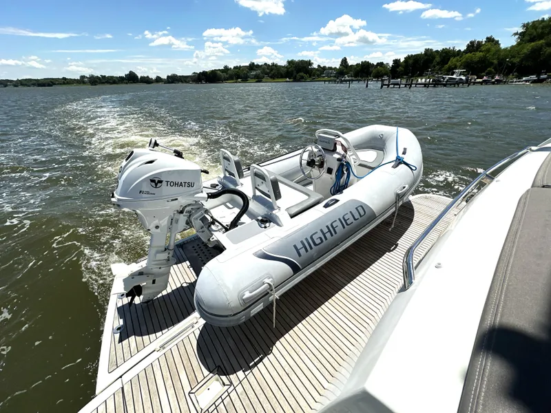 Slide: The Image of Inflatable boat with Tohatsu motor on Prestige 500 yacht, 2017 model, cruising on a sunny lake. - 7