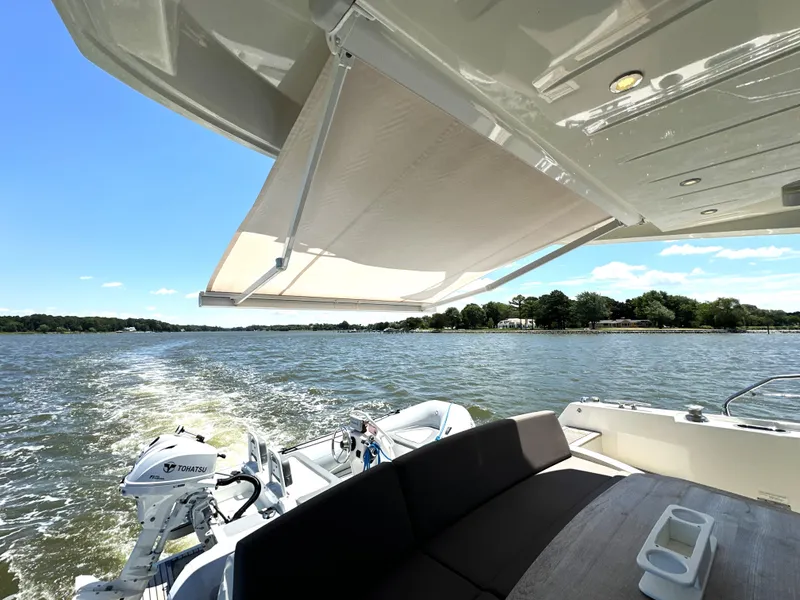 Slide: The Image of 2017 Prestige 500 yacht with awning, cruising on a sunny lake. - 9