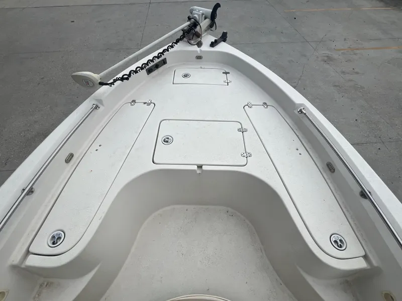 Slide: The Image of 2015 Sea Chaser 210 LX Bay Runner boat deck with storage compartments and trolling motor. - 12