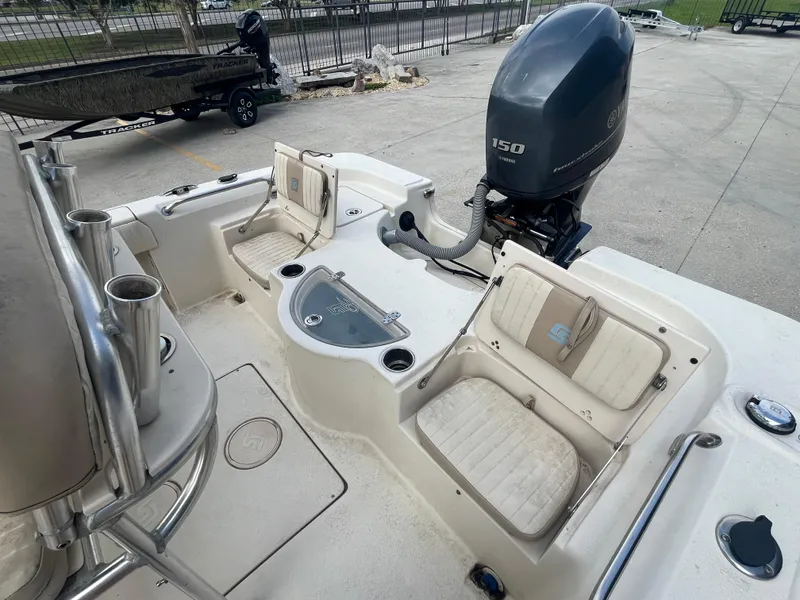 Slide: The Image of 2015 Sea Chaser 210 LX Bay Runner boat interior with seating and outboard motor. - 15