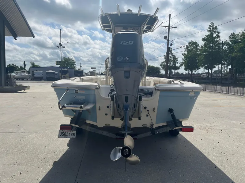 Slide: The Image of 2015 Sea Chaser 210 LX Bay Runner boat with outboard motor, parked outdoors. - 7