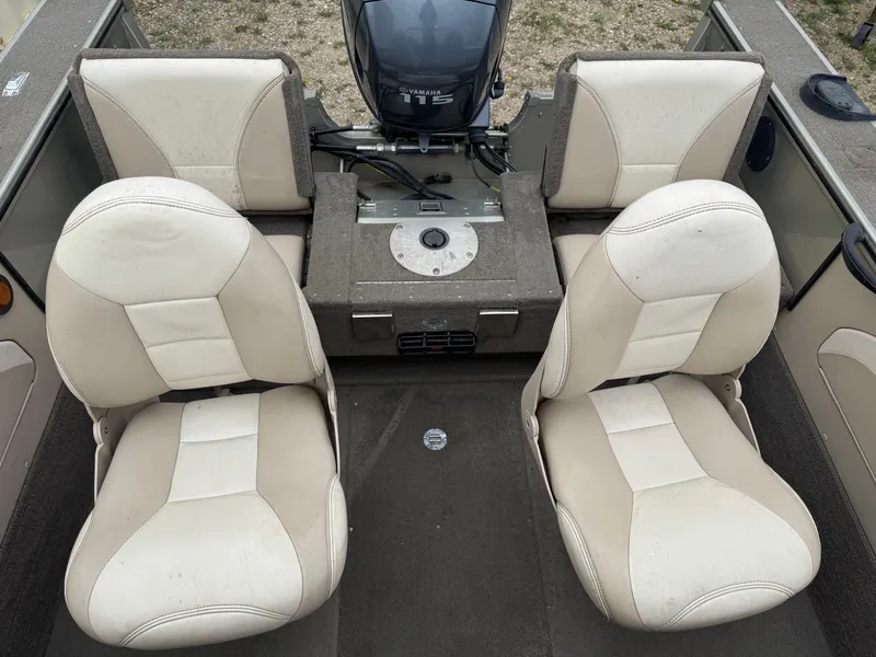 Slide: The Image of 2004 Alumacraft Trophy 175 boat interior with beige seating and console details. - 11