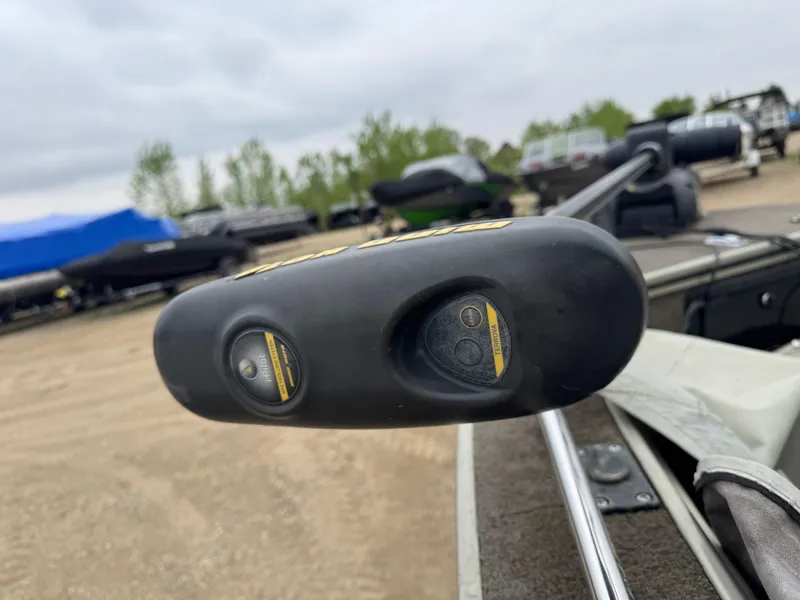 Slide: The Image of 2004 Alumacraft Trophy 175 boat interior with two beige seats and Yamaha motor. - 12