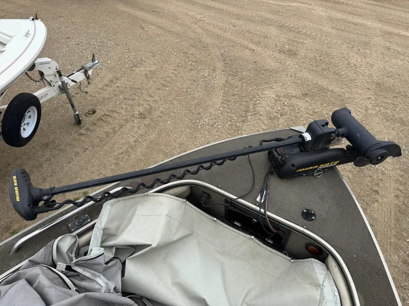 Slide: The Image of 2004 Alumacraft Trophy 175 boat interior with seating and motor view. - 13