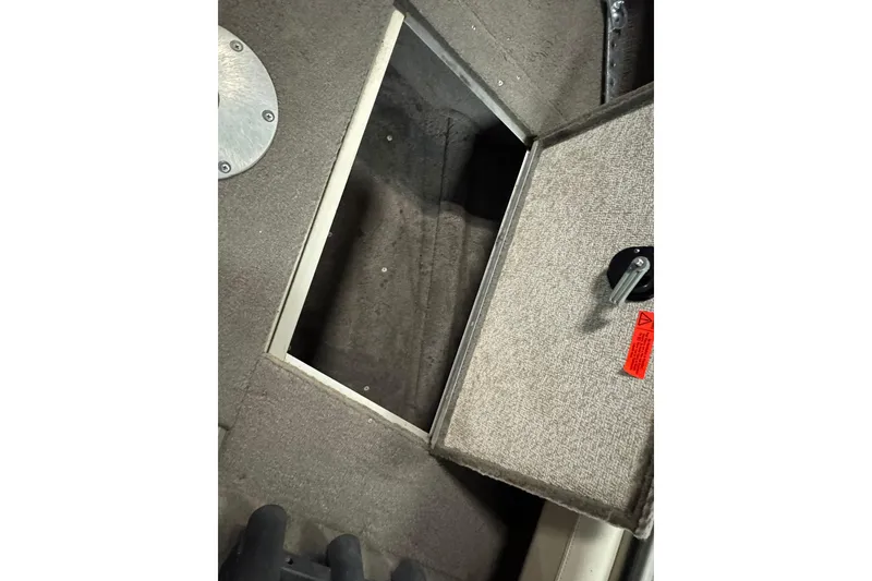 Slide: The Image of Open storage compartment in 2004 Alumacraft Trophy 175 boat interior. - 16