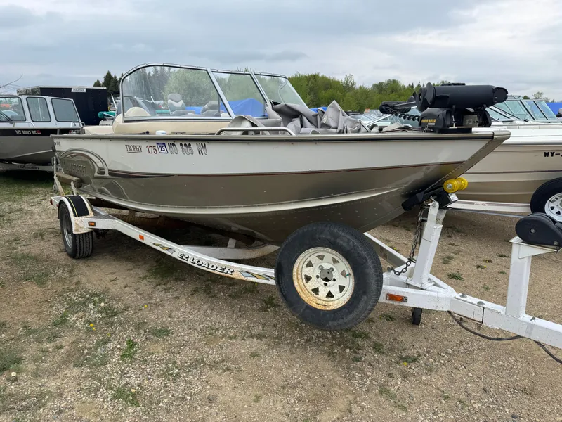 Slide: The Image of 2004 Alumacraft Trophy 175 boat on trailer in indoor storage facility. - 2