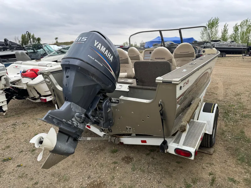 Slide: The Image of 2004 Alumacraft Trophy 175 boat with Yamaha outboard motor in a garage setting. - 3