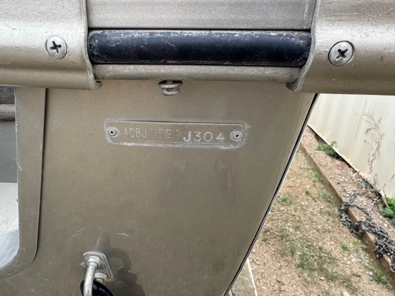 Slide: The Image of 2004 Alumacraft Trophy 175 boat interior with four beige seats in a workshop setting. - 5