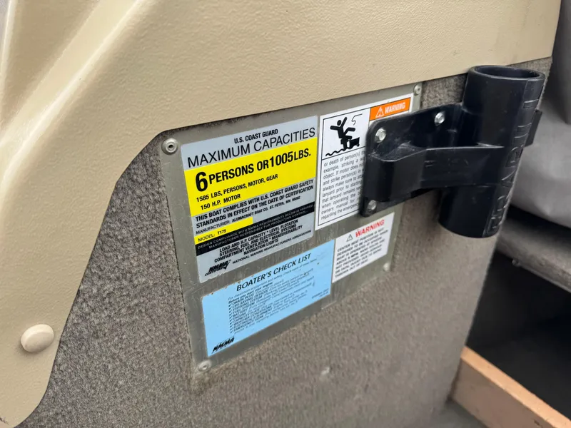 Slide: The Image of 2004 Alumacraft Trophy 175 boat dashboard with steering wheel and instrument panel. - 9