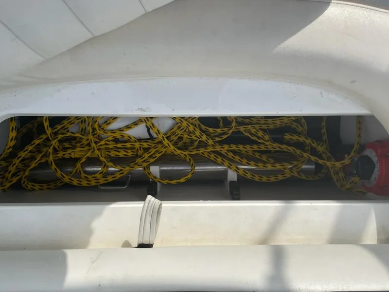 Slide: The Image of Storage compartment with yellow rope in a 2005 Cobalt 246 boat. - 11