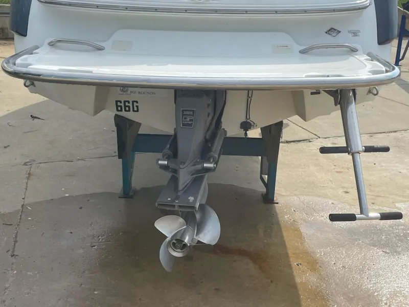 Slide: The Image of Rear view of a 2005 Cobalt 246 boat on a trailer, showing the propeller and swim platform. - 16