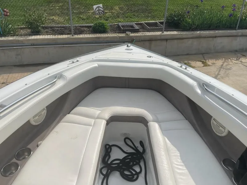 Slide: The Image of 2005 Cobalt 246 boat interior with white seating and coiled rope. - 6