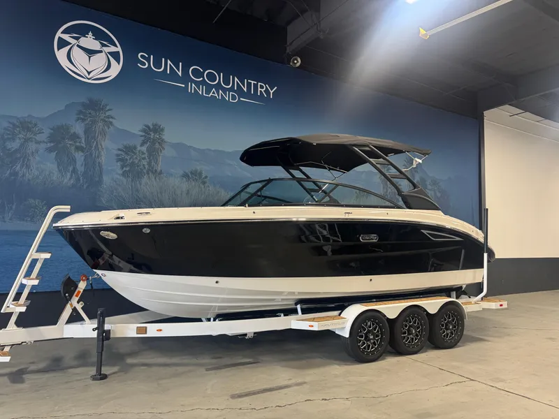 Slide: The Image of 2025 Sea Ray SDX 250 boat interior with white seating and modern dashboard. - 2