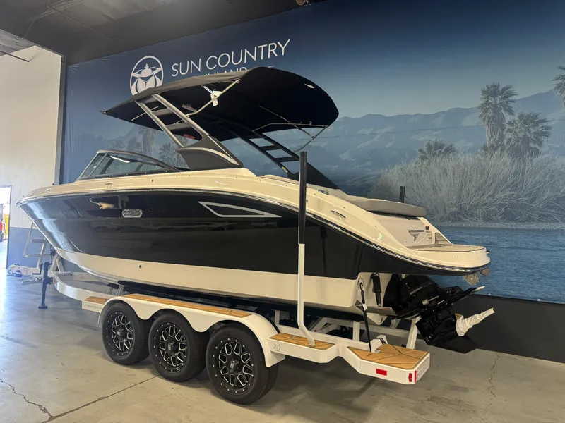 Slide: The Image of 2025 Sea Ray SDX 250 boat on trailer in showroom, featuring sleek design and modern amenities. - 3