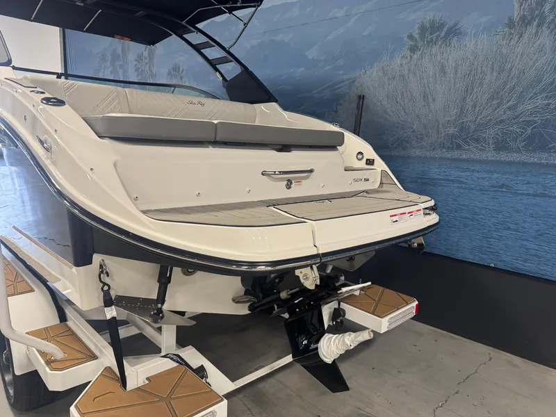 Slide: The Image of 2025 Sea Ray SDX 250 helm with dual Simrad displays and modern steering wheel. - 4
