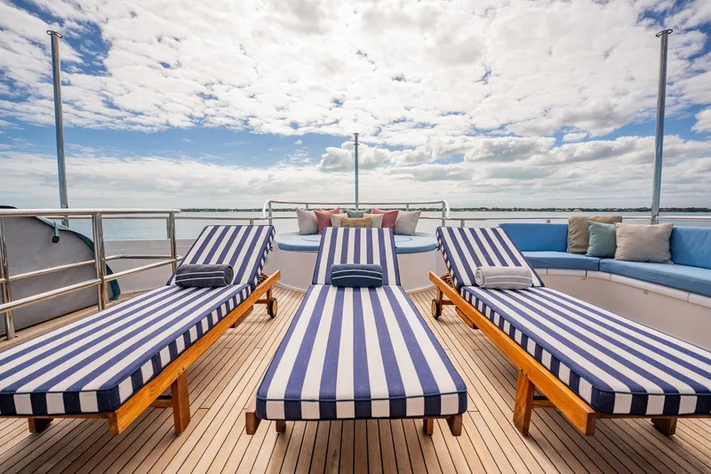 Slide: The Image of Luxurious deck of 1996 Cheoy Lee 145 Global Series yacht with striped loungers. - 24