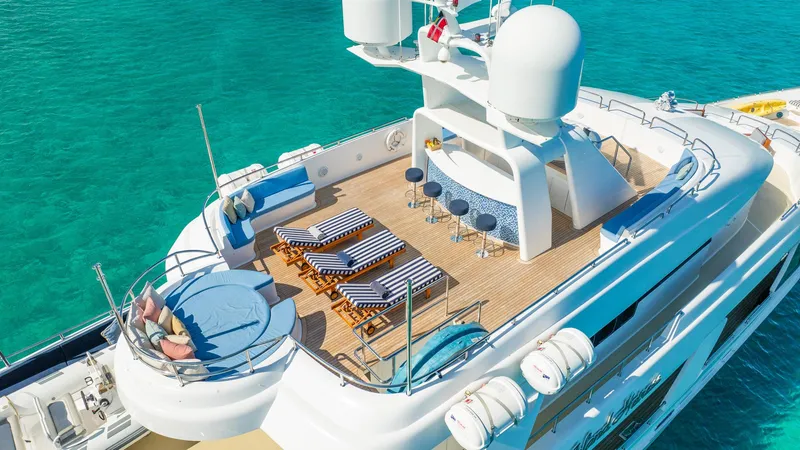 Slide: The Image of Luxurious 1996 Cheoy Lee 145 Global Series yacht with sun deck and bar, in turquoise waters. - 8