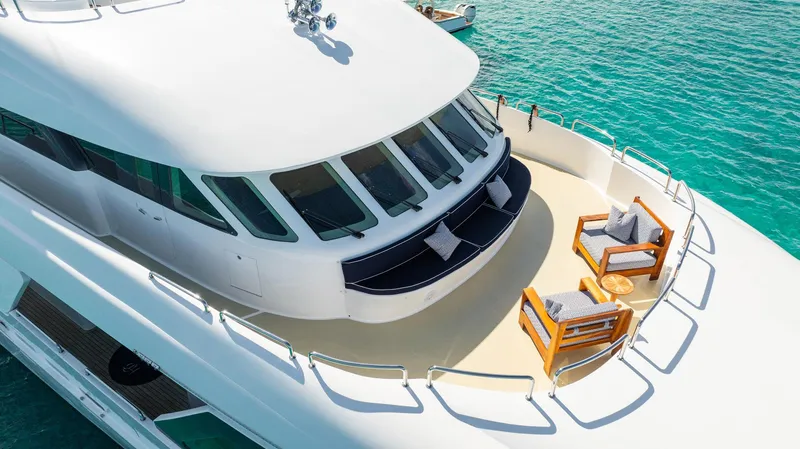 Slide: The Image of Luxurious 1996 Cheoy Lee 145 Global Series yacht deck with seating, overlooking turquoise waters. - 9