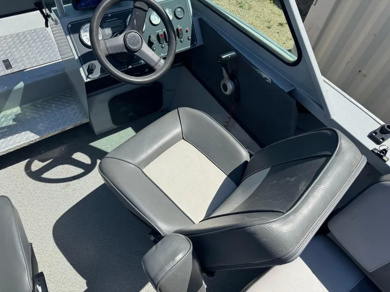 Slide: The Image of 2017 Smoker Craft 202 Phantom boat interior with steering wheel and seating. - 10