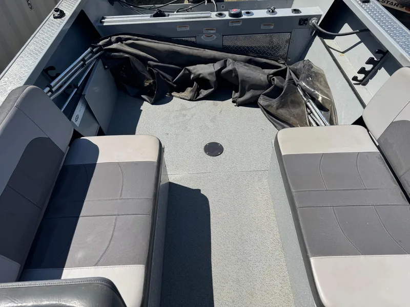 Slide: The Image of 2017 Smoker Craft 202 Phantom boat interior with gray seating and storage area. - 13