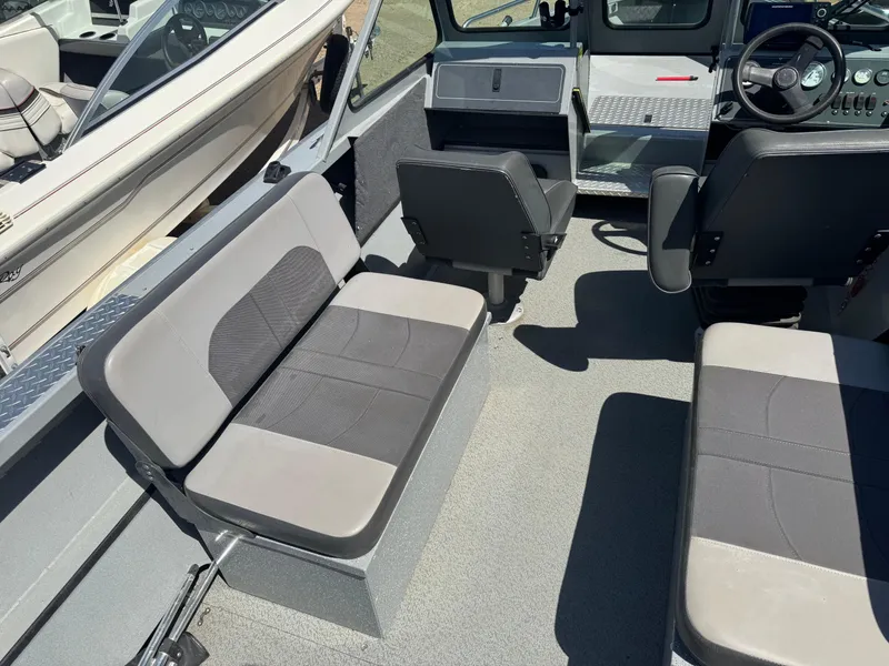 Slide: The Image of 2017 Smoker Craft 202 Phantom boat interior with gray seating and steering console. - 7
