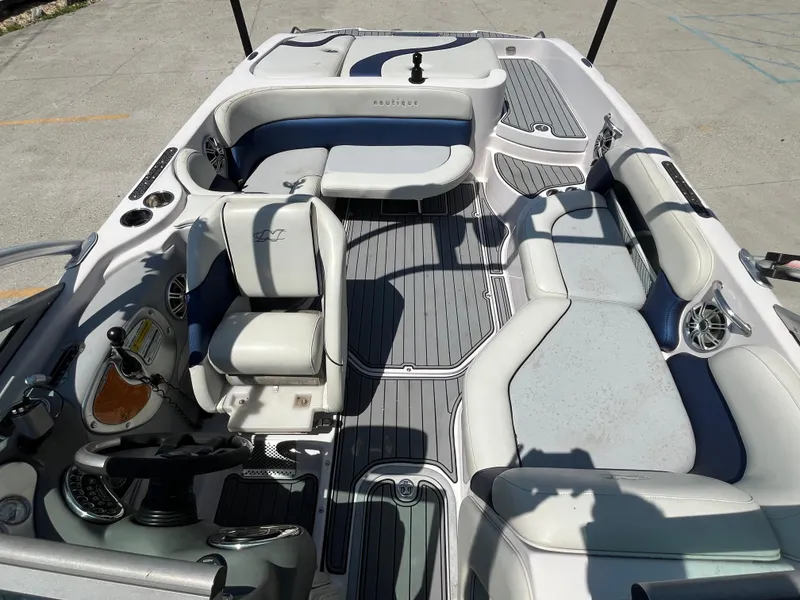 Slide: The Image of 2006 Nautique Air SV-211 Team boat interior with white and gray seating, steering wheel, and controls. - 13