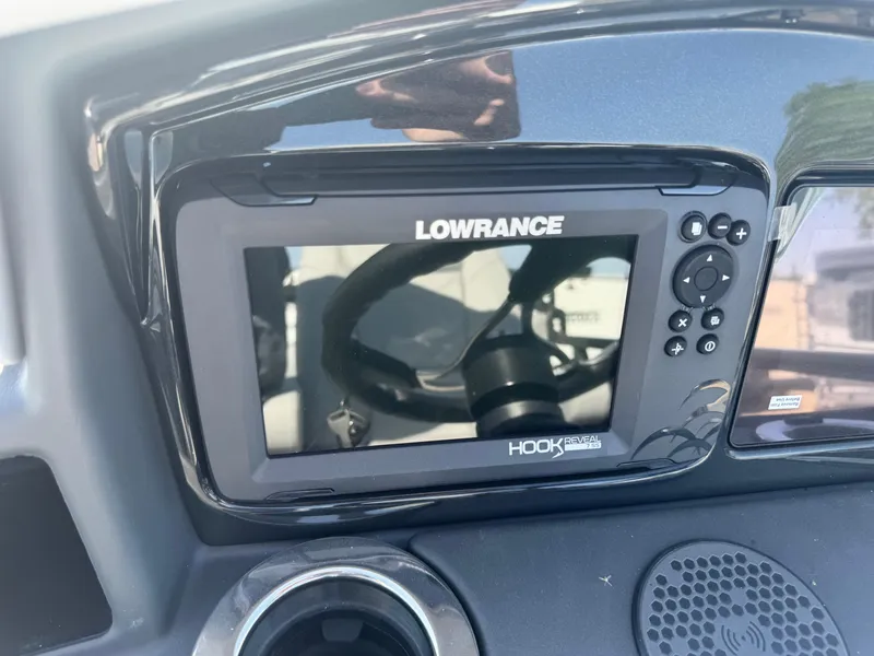 Slide: The Image of Console of 2024 Regency 230 DL3 with Lowrance Hook Reveal display. - 12