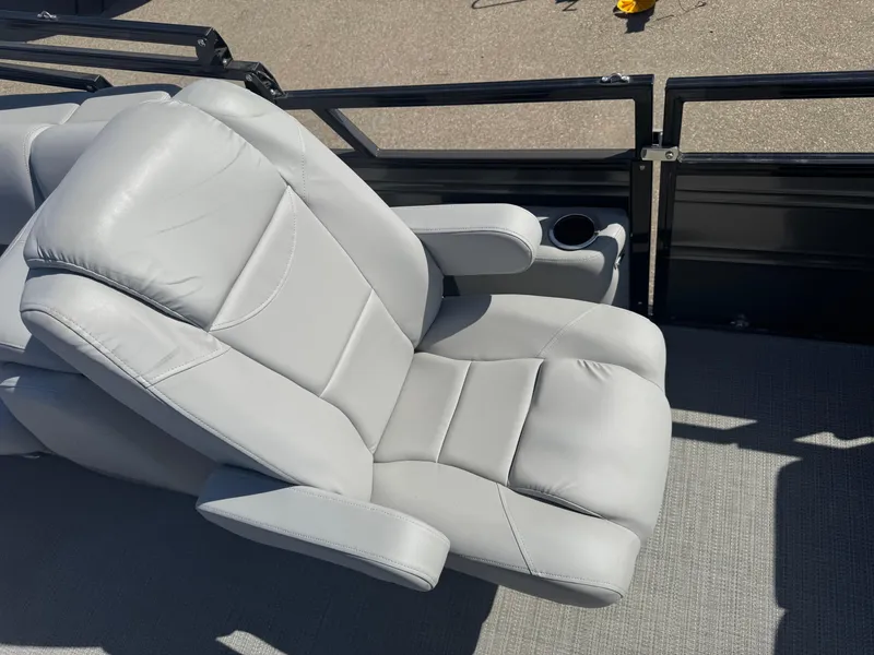 Slide: The Image of 2024 Regency 230 DL3 boat seating with cup holder, featuring light gray upholstery. - 15